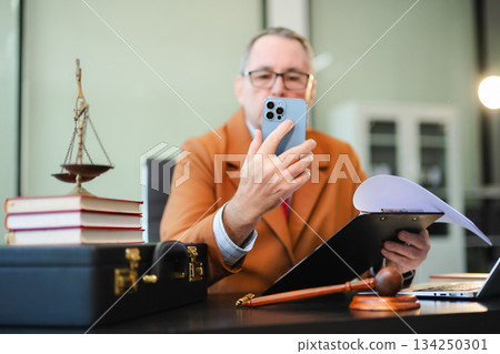 Male judge in courtroom, lawyer working in office. Perfect for business, legal advice, corporate law Male judge in courtroom, lawyer working in office. Perfect for business, legal advice, corporate law 134250301