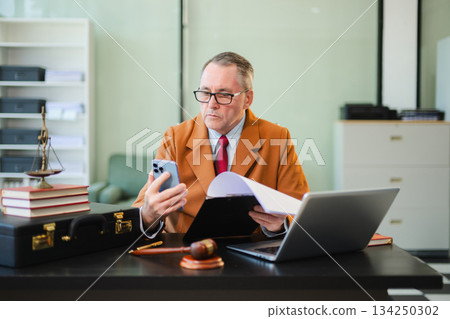 Man lawyer working and gavel, tablet, laptop in front, Advice justice and law concept. Man lawyer working and gavel, tablet, laptop in front, Advice justice and law concept. 134250302