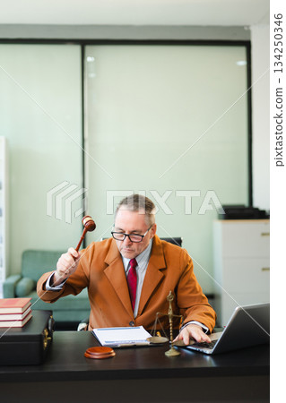 Caucasian male judge in courtroom, lawyer working in office. Perfect for business, legal advice, corporate law Caucasian male judge in courtroom, lawyer working in office. Perfect for business, legal advice, corporate law 134250346