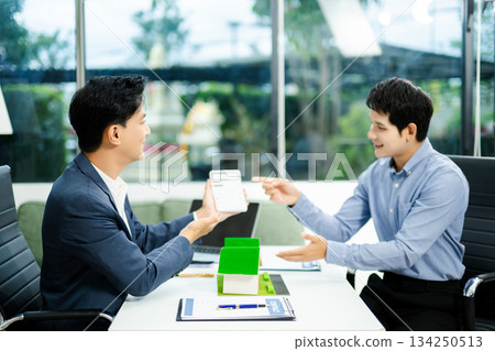 Real estate broker agent presenting and consult to customer to decision making sign insurance form agreement, home model Real estate broker agent presenting and consult to customer to decision making sign insurance form agreement, home model 134250513