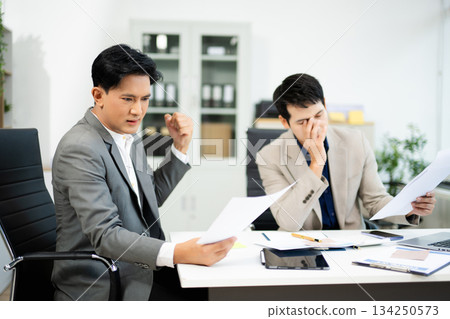 Frustrated manager scolds employee in office over financial error. Concept of workplace stress, reporting issues, conflict Frustrated manager scolds employee in office over financial error. Concept of workplace stress, reporting issues, conflict 134250573