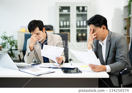 Frustrated manager scolds employee in office over financial error. Concept of workplace stress, reporting issues, conflict Frustrated manager scolds employee in office over financial error. Concept of workplace stress, reporting issues, conflict 134250574