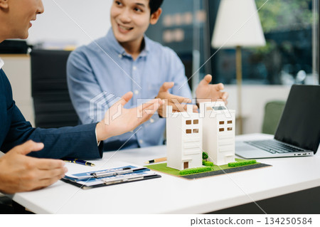 Signing a contract. Client and broker agent, lease agreement, successful deal and Young business sitting at the desk Signing a contract. Client and broker agent, lease agreement, successful deal and Young business sitting at the desk 134250584
