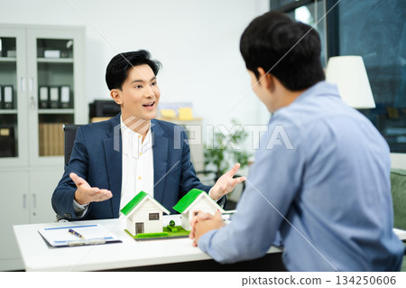 Professional team collaboration in modern office, discussing real estate model and signing contract, concept of startup Professional team collaboration in modern office, discussing real estate model and signing contract, concept of startup 134250606