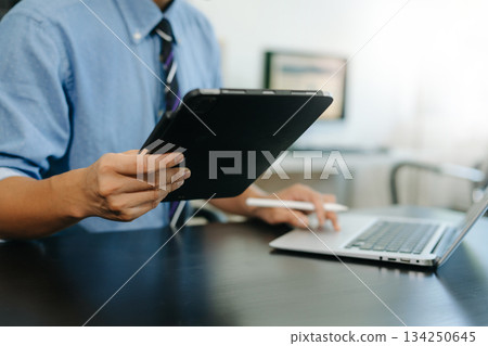 Businessman hand using smart phone laptop and tablet with social network diagram on desk as concept Businessman hand using smart phone laptop and tablet with social network diagram on desk as concept 134250645