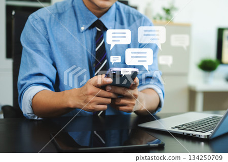 Man hands User typing on smartphone and tablet chatting conversation in chat box icon pop up for social media marketing technology concept. Man hands User typing on smartphone and tablet chatting conversation in chat box icon pop up for social media marketing technology concept. 134250709