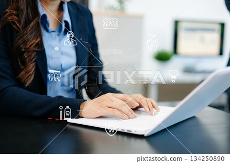 Professional using smartphone with digital holographic dental icons, showcasing innovation, modern healthcare technology, and advanced dentistry solutions 134250890