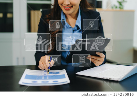 lose up of businesswoman working with laptop computer and smart phone on desk in modern office 134250916