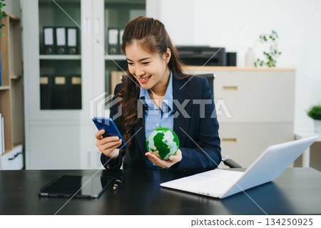 Asian Businesswoman Analyzing Finance on Tablet and Laptop at modern Office Desk tax, report, accounting, statistics 134250925