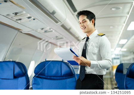 Professional airline pilot inspecting airplane cabin during safety check, perfect for aviation, travel, and airline safety concept stock photography Professional airline pilot inspecting airplane cabin during safety check, perfect for aviation, travel, and airline safety concept stock photography 134251095
