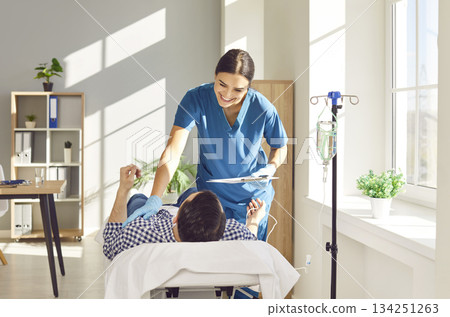 Nurse supporting and giving consultation to patient receiving IV drip infusion therapy Nurse supporting and giving consultation to patient receiving IV drip infusion therapy 134251263