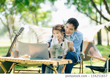 Happy parents and daughter Bakery and Bread Fruit enjoy in a sunny garden. A joyful summer picnic full of love Happy parents and daughter Bakery and Bread Fruit enjoy in a sunny garden. A joyful summer picnic full of love 134251657