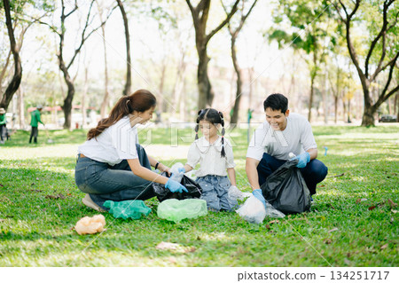Asian parents and child collect bottles at the park, sharing love, teamwork, and care. A green lifestyle moment promoting recycling, unity Asian parents and child collect bottles at the park, sharing love, teamwork, and care. A green lifestyle moment promoting recycling, unity 134251717