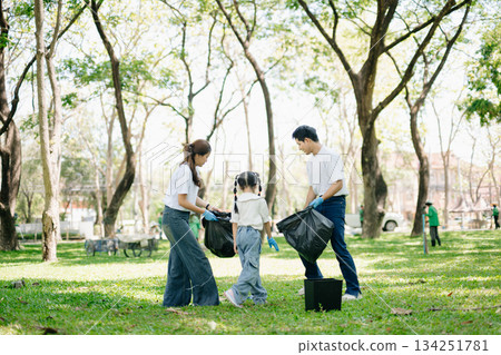 Asian parents and child collect trash in the forest, promoting recycling, unity, and ecology. A heartwarming scene of love, care, teamwork Asian parents and child collect trash in the forest, promoting recycling, unity, and ecology. A heartwarming scene of love, care, teamwork 134251781