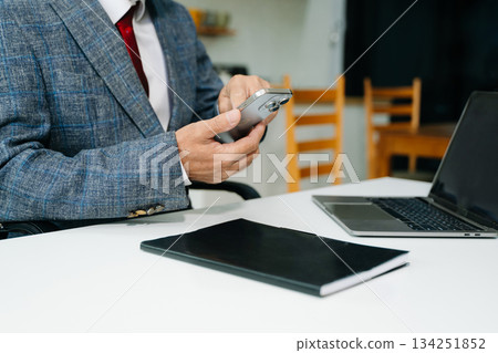 Businessman s hands typing on smartphone, tablet and laptop keyboard computer, Businessman s hands typing on smartphone, tablet and laptop keyboard computer, 134251852