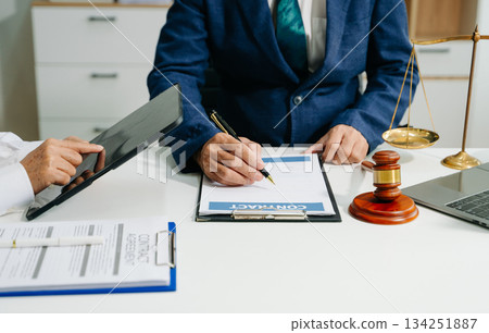 Business and lawyers discussing contract papers with brass scale on desk in office. Law, legal services, advice Business and lawyers discussing contract papers with brass scale on desk in office. Law, legal services, advice 134251887