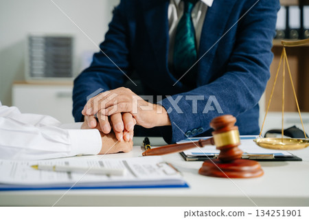 Business people compassionately holding hands and discussing contract papers with laptop and tablet Business people compassionately holding hands and discussing contract papers with laptop and tablet 134251901