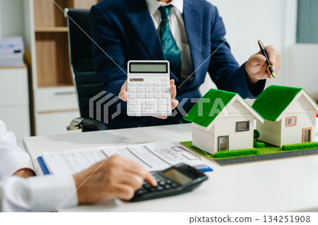 Real estate broker agent presenting and consult to customer to decision making sign insurance form agreement, home model Real estate broker agent presenting and consult to customer to decision making sign insurance form agreement, home model 134251908