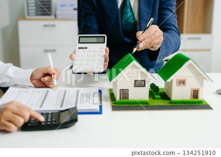 Real estate broker agent presenting and consult to customer to decision making sign insurance form agreement, home model Real estate broker agent presenting and consult to customer to decision making sign insurance form agreement, home model 134251910