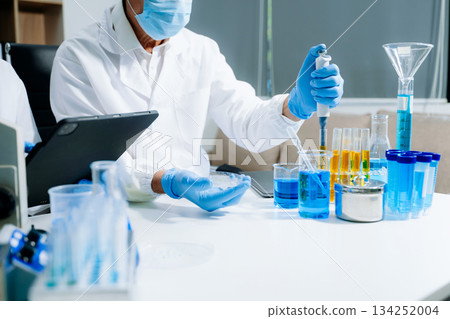 Scientist team meeting and writing analysis results in the laboratory study and analyze scientific sample 134252004