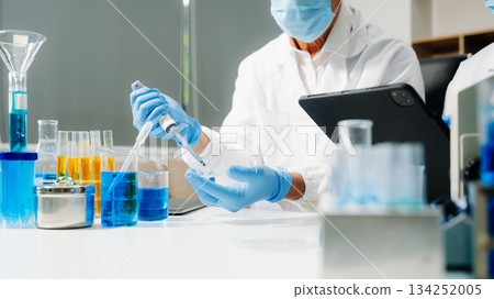 Scientist team meeting and writing analysis results in the laboratory study and analyze scientific sample 134252005