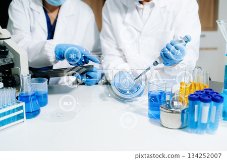 Modern medical research laboratory. female scientist hands working with micro pipettes analyzing biochemical samples 134252007