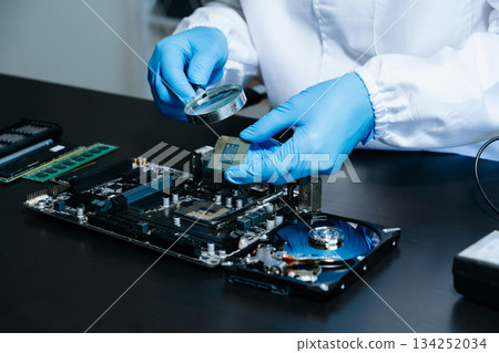 The technician is putting the CPU on the socket of the computer motherboard. electronic engineering electronic The technician is putting the CPU on the socket of the computer motherboard. electronic engineering electronic 134252034