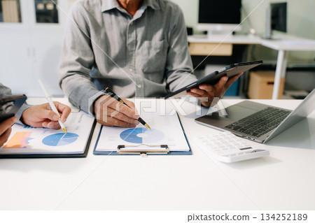 Business documents on office table with smart phone and calculator digital tablet and graph business Business documents on office table with smart phone and calculator digital tablet and graph business 134252189
