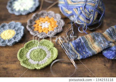 Balls of yarn, knitting needles, and craft projects 134253118