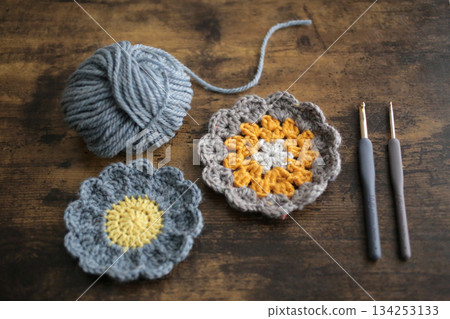 Balls of yarn, knitting needles, and craft projects 134253133
