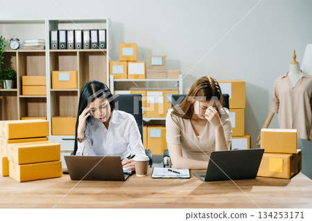 Asian team owner woman prepare parcel box woman is stressed, bored, and overthinking from working Asian team owner woman prepare parcel box woman is stressed, bored, and overthinking from working 134253171