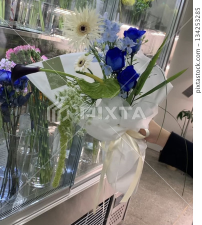 Bouquet of fresh flowers with vibrant colorful petals and lush green leaves, carefully arranged to highlight natural beauty, soft textures, and harmonious elegance in close-up detail 134253285