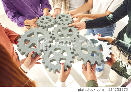 Gear elements team hands holding, teambuilding mechanically engineering toy 134253373