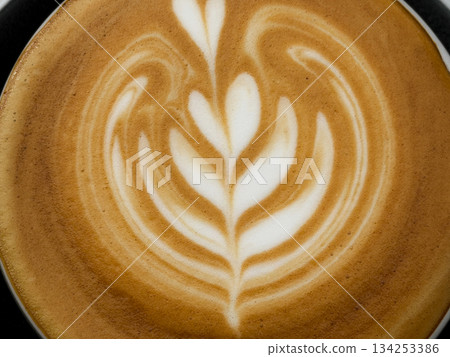 Hot coffee, a hot latte in a mug on a wooden table. 134253386