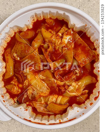 Yeoptteok, a spicy Korean rice cake dish combining chewy tteokbokki with intensely flavored sauce, often paired with fish cakes and boiled eggs. Known for its fiery heat and bold flavors. 134253829
