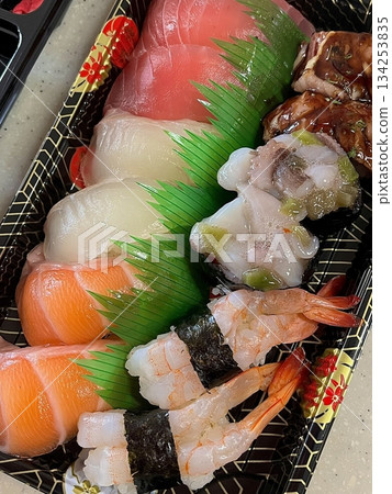 An assortment of fresh sushi, artfully arranged with a variety of toppings and vibrant colors. This traditional Japanese dish combines vinegared rice, seafood, and vegetables for an experience. 134253835