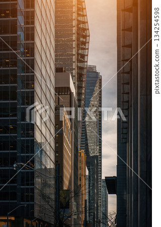 city street with tall skyscrapers buildings, modern architecture of steel and glass, skyline of big city 134254598