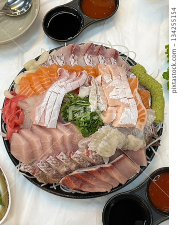 Fresh and delicate sashimi slices, beautifully presented with vibrant colors and perfect cuts. This traditional Japanese delicacy highlights the pure flavors of premium seafood. 134255154