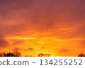 Dramatic Golden Hour Sunset Sky with Vibrant Orange and Red Clouds 134255252