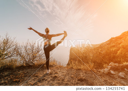 Yoga on a Clifftop Overlooking the Sea at Sunset Yoga on a Clifftop Overlooking the Sea at Sunset 134255741