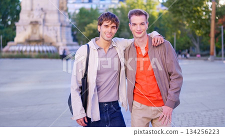Smiling gay couple embracing showing inclusivity in city Smiling gay couple embracing showing inclusivity in city 134256223
