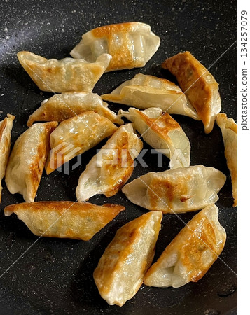Delicious Korean mandu dumplings with a golden, crispy exterior and flavorful filling. Perfect as an appetizer, snack, or side dish, offering a delightful taste in every bite. Delicious Korean mandu dumplings with a golden, crispy exterior and flavorful filling. Perfect as an appetizer, snack, or side dish, offering a delightful taste in every bite. 134257079