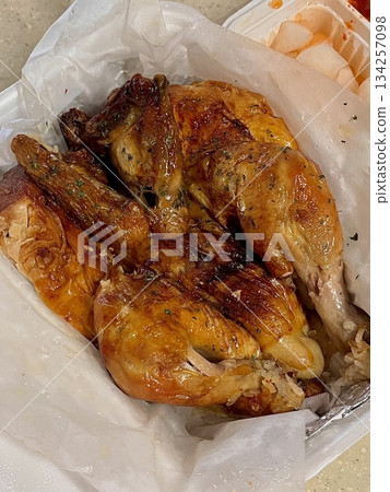 Traditional Korean whole fried chicken with crispy golden skin, served simply to highlight its rustic style, tender meat, and savory flavor reminiscent of classic homemade cooking 134257098