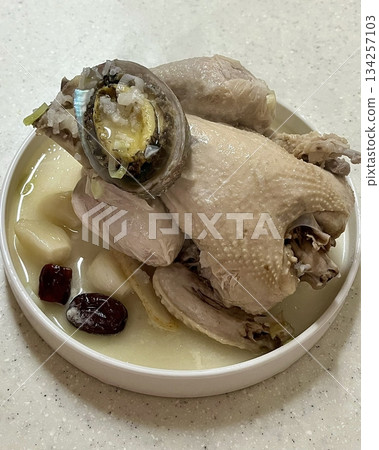 Samgyetang, a hearty Korean ginseng chicken soup, featuring a whole young chicken stuffed with rice, garlic, jujube, and herbs. A nourishing dish perfect for health and comfort. Samgyetang, a hearty Korean ginseng chicken soup, featuring a whole young chicken stuffed with rice, garlic, jujube, and herbs. A nourishing dish perfect for health and comfort. 134257103