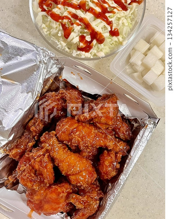 Crispy Korean fried chicken, perfectly glazed with a sweet and spicy sauce. Ideal for food photography and menus, showcasing the irresistible crunch and flavor of this beloved dish. Crispy Korean fried chicken, perfectly glazed with a sweet and spicy sauce. Ideal for food photography and menus, showcasing the irresistible crunch and flavor of this beloved dish. 134257127