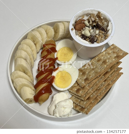 A delightful brunch spread featuring a mix of savory and sweet dishes, including fresh pastries, eggs, seasonal fruits, and a hot beverage. A perfect mid-morning indulgence. 134257177