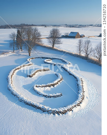 Ancient Stone Ship Setting Amongst Snowy Plains Under a Clear Blue Sky 134258710