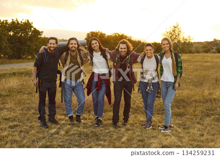 Group of friends tourists trekking with backpacks during a walking tour in nature. Group of friends tourists trekking with backpacks during a walking tour in nature. 134259231