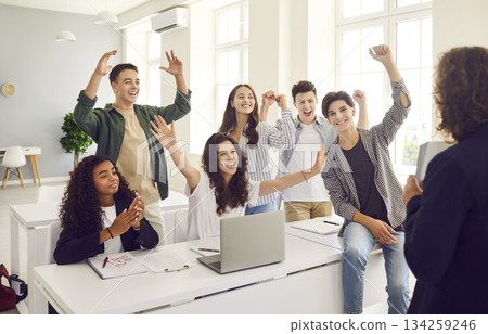 Group of happy teenage school students celebrate success in computer science class 134259246