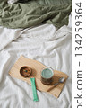 Green smoothie, dietary supplements and spoon on wooden tray on bed. 134259364